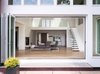 Modern home with Outdoor, Metal Patio, Porch, Deck, Pavers Patio, Porch, Deck, Raised Planters, and Back Yard. View from exterior to interior with open doors Photo 4 of The River House