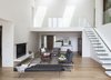 Modern home with Living Room, Bench, Coffee Tables, Sofa, End Tables, Chair, Two-Sided Fireplace, and Recessed Lighting. View from living room to front entry door and upper baclony Photo 6 of The River House