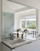 Modern home with Bath Room, Engineered Quartz Counter, Porcelain Tile Floor, Drop In Sink, Open Shower, Recessed Lighting, Freestanding Tub, Wall Lighting, One Piece Toilet, and Porcelain Tile Wall. Bathroom Detail Photo 13 of The River House