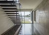 Modern home with Staircase, Wood Tread, and Glass Railing. Entry hall and stairs Photo 9 of Long Island Sound House