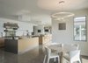 Modern home with Kitchen, Glass Tile Backsplashe, White Cabinet, Metal Counter, Recessed Lighting, Accent Lighting, Ceiling Lighting, Range, Mosaic Tile Backsplashe, Range Hood, Dishwasher, Refrigerator, Wall Oven, Microwave, and Drop In Sink. Breakfast and Kitchen Photo 17 of Long Island Sound House