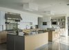 Modern home with Kitchen, Mosaic Tile Backsplashe, Metal Counter, Concrete Floor, White Cabinet, Recessed Lighting, Glass Tile Backsplashe, Ceiling Lighting, Wall Oven, Range Hood, Accent Lighting, Dishwasher, Refrigerator, Drop In Sink, and Microwave. Kitchen Photo 19 of Long Island Sound House