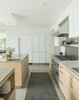 Modern home with Kitchen, Concrete Floor, Stone Counter, White Cabinet, Metal Counter, Mosaic Tile Backsplashe, Glass Tile Backsplashe, Metal Backsplashe, Accent Lighting, Recessed Lighting, Refrigerator, Ceiling Lighting, Range Hood, and Drop In Sink. Kitchen Photo 20 of Long Island Sound House