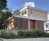Modern home with Exterior, Concrete Siding Material, House Building Type, Stucco Siding Material, Stone Siding Material, Wood Siding Material, Flat RoofLine, and Metal Roof Material. Street view showing glimpse of side elevation Photo of Old Greenwich House
