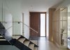 Modern home with Staircase, Metal Tread, Wood Tread, and Glass Railing. Entry foyer looking door door and smart glass sidelight. Tatami room on right. Photo 3 of Old Greenwich House