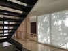 Modern home with Staircase, Metal Tread, Glass Railing, and Wood Tread. Coming up the stairs from lower level . Tatami room in distance. Photo 6 of Old Greenwich House