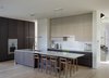 Modern home with Kitchen, Engineered Quartz Counter, Wood Cabinet, Cooktops, Light Hardwood Floor, Pendant Lighting, Microwave, Dishwasher, Wall Oven, Glass Tile Backsplashe, Refrigerator, Range Hood, Wine Cooler, and Drop In Sink. The kitchen. Photo 8 of Old Greenwich House