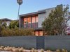 Modern home with Exterior, Stucco Siding Material, Wood Siding Material, Flat RoofLine, Metal Roof Material, and House Building Type. Street view of Woodlawn Ave located in Venice Beach Ca Photo of Wylan/James Residence