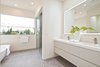 Modern home with Bath Room, Ceiling Lighting, One Piece Toilet, Wall Mount Sink, Ceramic Tile Floor, Porcelain Tile Floor, Freestanding Tub, Stone Counter, and Full Shower. Master bathroom with palm tree lined ocean views. Custom Sinks by Furgeson, Flooring by Porcelenosa. Photo 4 of Wylan/James Residence