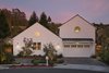 Right-sized house in a country setting is perfect for a couple enjoying retirement. White paint contrasts with surroundings. Photo of A New Beginning modern home