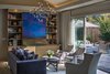 Furnishings provide for a six person conversation group with a wall of glass leading to an inviting outdoor room as large as the indoor space. Media is hidden behind custom art doors. Photo 2 of A New Beginning modern home