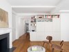 Built in custom millwork conceals the entertainment center and connects to the adjacent kitchen cabinets and counter top. Photo of Prewar Modern Upgrade modern home
