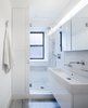 A wall mounted vanity, glass enclosed shower and built in cabinets seek to maximizes the feeling of space within a very tight footprint. Photo 6 of Prewar Modern Upgrade modern home