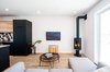 Living room with JOTUL fireplace and FSC oiled maple floors Photo of Concept DUB House modern home