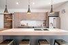 Modern home with Kitchen, Engineered Quartz Counter, Wood Cabinet, Stone Slab Backsplashe, Pendant Lighting, Refrigerator, and Undermount Sink. Good view of the Calacatta gold counter addition and backsplash. Barndoor to the left gives the owners access to a walk-in pantry. Photo 5 of James house