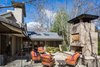 The patio area is sheltered by part of a roof that Winn designed for the original home in 1979. Notice the shape of the chimney cap and the new fireplace's chimney. Photo 9 of Mid-century Modern Gathering Space modern home