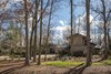 The 1979 house was designed by Sumner Winn, an RISD graduate, a Chapel Hill-based midcentury modern architect, a friend of Arielle Schechter's architect father, and one of her favorite people when she was a child. Winn set the house deeply into its wooded site. Photo of Mid-century Modern Gathering Space modern home
