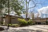 To the left of the broad drive/car court, a new paved walkway leads visitors to the addition out back. Photo 4 of Mid-century Modern Gathering Space modern home