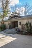 The main entrance. The shape of the chimney cap is a defining architectural feature that Schechter used on her addition as a nod to the original architect. Photo 3 of Mid-century Modern Gathering Space modern home