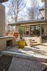 At the end of the paved path, the entrance to the new outdoor gathering space unfolds. Photo 6 of Mid-century Modern Gathering Space modern home