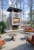 In keeping with the modernist details of the house, Schechter designed the fireplace with a dramatic cantilevered front instead of a mantle. Other details drawn from the original house include the shape of the chimney cap and the matching stucco skin. Photo 10 of Mid-century Modern Gathering Space modern home