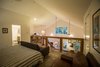 Modern home with Accent Lighting and Chair. The loft provides a guest room, bath, and home office. Photo 19 of Modern, Passive, Net Zero Farmhouse