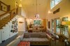 Modern home with Living Room, Concrete Floor, Sofa, Wall Lighting, Chair, Gas Burning Fireplace, Bookcase, and Coffee Tables. Behind its relaxed, farmhouse charm, this seemingly simple house was built to PHIUS standards, one of the strictest sustainable building standards in the world. Photo 16 of Modern, Passive, Net Zero Farmhouse