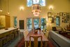 Modern home with Dining Room, Stools, Concrete Floor, Table, Pendant Lighting, Chair, Bench, and Accent Lighting. Immediately inside the front door, the home’s modern underpinning Is revealed by the open floor plan. The kitchen (left), dining area (center) and living space (right) become one “great room,” united not only by fluid space but also by the polished concrete floor. Photo 7 of Modern, Passive, Net Zero Farmhouse