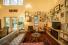 Modern home with Living Room, Gas Burning Fireplace, Bookcase, Concrete Floor, Coffee Tables, Wall Lighting, Sofa, and Chair. A small fireplace is tucked into built-in bookcases. The owners’ collection of prints and photographs wrap around the two windows. Photo 9 of Modern, Passive, Net Zero Farmhouse