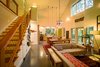 Wire fencing first seen on the porch reappears at the staircase and loft above. Photo 18 of Modern, Passive, Net Zero Farmhouse modern home