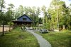 Modern home with Exterior, Metal Roof Material, Concrete Siding Material, Gable RoofLine, and Farmhouse Building Type. The wrap-around porch is perfect for wooded site in a clearing surrounded by deciduous trees. The front portion of the porch overlooks gardens and play space. Photo 3 of Modern, Passive, Net Zero Farmhouse