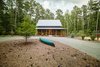 Modern home with Exterior, Farmhouse Building Type, Gable RoofLine, Metal Roof Material, and Concrete Siding Material. The client wanted something “very, very simple…reminiscent of the vernacular tobacco barns and farmhouses of old North Carolina.” Photo of Modern, Passive, Net Zero Farmhouse