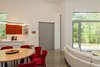 Modern home with Living Room, Pendant Lighting, Recessed Lighting, Concrete Floor, Sofa, Track Lighting, and Sectional. View from the back porch to the front door. Photo 8 of The Serdar Net Zero-Net Positive Micropolis® House