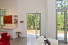 Modern home with Living Room, Sectional, Recessed Lighting, Pendant Lighting, Track Lighting, and Concrete Floor. The pivoting door is an intriguing and practical solution to spatial conservation. Photo 9 of The Serdar Net Zero-Net Positive Micropolis® House