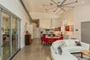 Modern home with Living Room, Coffee Tables, Concrete Floor, Pendant Lighting, Sectional, and Recessed Lighting. A view down the length of the one-room-deep main living space. Photo 11 of The Serdar Net Zero-Net Positive Micropolis® House