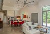 Modern home with Living Room, Recessed Lighting, Concrete Floor, Track Lighting, Pendant Lighting, Sectional, and Coffee Tables. View from the living room to the dining area and kitchen. The floor is polished concrete. Photo 10 of The Serdar Net Zero-Net Positive Micropolis® House