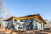 Modern home with Exterior, Concrete Siding Material, Metal Roof Material, Shed RoofLine, and House Building Type. The western elevation. Photo 6 of The Serdar Net Zero-Net Positive Micropolis® House