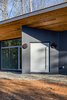 Modern home with Exterior, House Building Type, Metal Roof Material, Shed RoofLine, and Concrete Siding Material. The angular entrance draws attention to the steel pivoting front door. Photo 3 of The Serdar Net Zero-Net Positive Micropolis® House