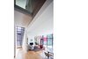 Modern home with Hallway and Medium Hardwood Floor. Double-height space serves as a transition between old and new. Photo 7 of Hillcrest House Addition: An Innovative Approach to Old + New