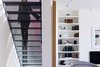 Modern home with Staircase, Metal Railing, and Metal Tread. To maintain the sense of transparency in the addition, local artisans fabricated a perforated metal staircase. Photo 8 of Hillcrest House Addition: An Innovative Approach to Old + New