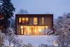 Modern home with Exterior, House Building Type, Metal Roof Material, Metal Siding Material, and Flat RoofLine. The modern addition in the snow at dusk. Photo of Hillcrest House Addition: An Innovative Approach to Old + New