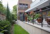 Modern home with Exterior, House Building Type, Metal Siding Material, Wood Siding Material, Flat RoofLine, and Metal Roof Material. The patio along one side of the house, concluding at the stacked screened porches. Photo 4 of The Thomas Residence