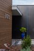 Modern home with Exterior, Metal Roof Material, House Building Type, Wood Siding Material, Flat RoofLine, and Metal Siding Material. Natural cedar is a warm counterpoint to the dramatic steel wall at the entrance. Photo 3 of The Thomas Residence