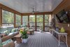 Modern home with Exterior, Flat RoofLine, House Building Type, Metal Roof Material, Wood Siding Material, and Metal Siding Material. The screened porch at the main living level. Photo 15 of The Thomas Residence