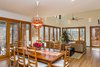 Modern home with Living Room, Sofa, Pendant Lighting, Ottomans, Two-Sided Fireplace, Table Lighting, Light Hardwood Floor, and Ceiling Lighting. An entire wall of the main living space is actually two sets of massive, triple-paned glass, Passive House-rated folding doors that literally open the interior to the outdoors overlooking Beech Forest. Photo 9 of The Mason-Grabell "Beech" House