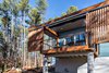 Modern home with Exterior, Wood Siding Material, Flat RoofLine, Glass Siding Material, Metal Roof Material, and House Building Type. Here, Schechter's sliding screens are in the open position at the master bedroom's private deck. Photo 6 of The Mason-Grabell "Beech" House