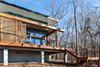 Modern home with Exterior, Wood Siding Material, Flat RoofLine, Glass Siding Material, House Building Type, and Metal Roof Material. Western sun in North Carolina is brutal in the summer months so Schechter designed sliding wood screens that can slide easily into a closed position to block the western sun and protect the owners from excessive heat gain.
Photo 5 of The Mason-Grabell "Beech" House