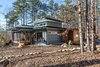 Modern home with Exterior, House Building Type, Flat RoofLine, and Metal Roof Material. Schechter designed the three-bedroom, 2465-square-foot house to be extremely energy efficient with a small solar array on the roof that elevates it easily to Net Zero status. Photo 14 of The Mason-Grabell "Beech" House