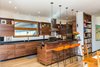 Modern home with Light Hardwood Floor and Pendant Lighting. in the kitchen, as throughout the interior, Schechter custom-designed the black walnut cabinetry to express its vivid grain and rich color. Photo 12 of The Mason-Grabell "Beech" House