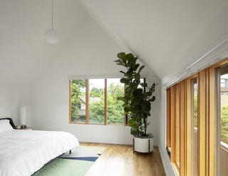 The third-floor master bedroom at Slender House. "It's like waking up in the clouds," homeowner Maja Henderson says.